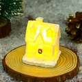 Close-up of white glowing resin miniature house with Christmas wreath and warm LED light - Style C