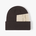 Gorro de punto café oscuro con un detalle de parche en contraste crema de trenzas - Café Oscuro