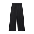 Detail of black wide-leg trousers with elastic waist and soft textured fabric - Black Pants