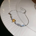Detailed macro view of yellow heart zircon pendant with sliding adjustable clasp chain - Silver-Yellow