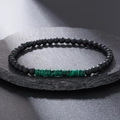 Macro detail of black matte beads and green striped malachite style stone on slate surface - ZJ11728-Black Matte Malachite Grain Bracelet