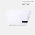 White corduroy cosmetic bag in hexagonal shape with vertical texture and black logo label - White Hexagon Bag