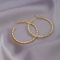 Textured gold hoop earrings with ribbed bead design on a luxurious silk background - 3D Thread Hoop / E-033---Gold