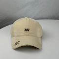 Close-up of distressed khaki baseball cap with brown letter embroidery and frayed brim detail - One Size (54-60cm) / Beige