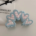 Close-up of sky blue hair claw clip with pink checkered heart patterns on jewelry card - Cream Blue Pink Heart