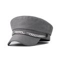 Macro detail of a grey beret hat with a silver metal chain and fabric texture - Gray