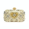Detail of evening clutch with champagne heart crystal inlay and pearl trim gold clasp - Champagne