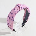 Detail of pink floral knotted headband showing the purple flower print and top twist texture - Printed Pink