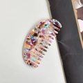 Acetate wide-tooth hair comb featuring a vibrant multicolored marble pattern - Patterned Oval