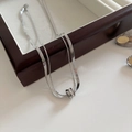 Double-layered silver titanium steel necklace with rhinestone interlocking rings on a jewelry box - Cylinder Ring / Steel