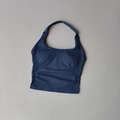 Detailed close-up of seamless halter yoga top featuring ribbed side panels and navy fabric - Grey Blue