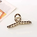 Elegant gold metal chain hair claw clip woven with dark brown silk ribbon on white background - Coffee
