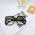 Oversized square black frame sunglasses with tea-colored gradient lenses on art book - Grey Green
