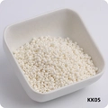 Macro shot of 3mm cream white glass seed beads in a white ceramic bowl model KK05 - KK05 Beige