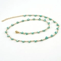 Detailed view of gold stainless steel heart Evil Eye necklace with turquoise enamel charms - Necklace / Green
