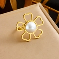 Detail showing gold hollow flower ring with a large center pearl on a textured plate - Hollow Heart Pearl Style (R469)