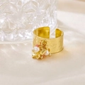 Close-up of golden wide open ring with irregular hammered texture and beaded star charms - R00899G (Hammered Wide Band + Star Pendant + Pink Bead + Pearl)