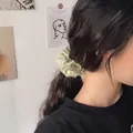 Green gingham scrunchie with daisy print pattern worn on a stylish high ponytail - Green Grid Daisy
