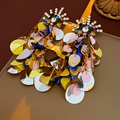Macro shot of colorful sequin tassel earrings with rhinestone sunflower stud details - Silver Earring Post - Colorful