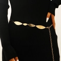 Detailed close-up of golden leaf tassel waist chain with hammered texture on black dress - KC Gold Leaf Style (11298)