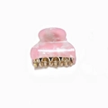 Close-up of a small pink marble acetate hair claw clip with golden metal teeth - Hot Pink