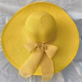Women's wide brim straw sun hat in bright yellow with a matching decorative bow ribbon - One Size (55-58cm) / Yellow