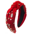 Detail of red knitted headband featuring white pearls, rhinestones and football charms - Red