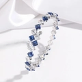 Detail of silver open bangle with square-cut blue and white cubic zirconia on silk - Blue