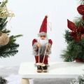 Detailed close-up of a skiing Santa Claus doll on a snowy background with festive decor - Red Coat Grey Trim Skiing Style
