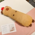 Soft long capybara plush pillow with a red apple topper on a cozy bed background - Capybara