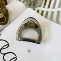 Close-up of translucent dark grey triangle shark hair clip with metal spring detail - Medium (approx. 6cm) / Transparent Black