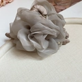 Detailed macro view of a vintage dusty purple organza flower hair claw with pearl detail - Grey Purple Gauze Flower Pearl Style