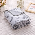 Detail of soft grey flannel pet blanket with paw prints and reinforced stitched edges - Carved Grey Paw Print