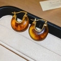 Close-up of vintage amber resin earrings in a beige jewelry box with soft natural lighting - 55# Earring Hoop-Gold-Brown-Vintage Amber Resin