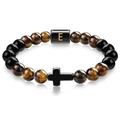 Macro detail of tiger eye bead bracelet with cross charm and golden letter E bead - Letter E