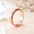 Detailed close-up of rose gold spinner ring with frosted finish and smooth inner band - US 5 / Rose Gold Sandblasted Spinner Ring