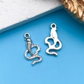 Vintage silver alloy snake charms with detailed scales and smooth silhouette design - Small Snake 9.5x18mm