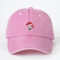 Pink washed cotton baseball cap with vintage mushroom embroidery in a front view - One Size / Pink