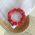 Red satin scrunchie with elegant pleated texture and subtle glossy finish for ponytails - Bright Red