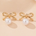 Detailed view of elegant gold bow earrings featuring a round white hanging pearl - Gold