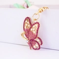 Cute butterfly keychain with pink rhinestones and white pearls on gold metal ring - Pink