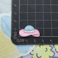 Miniature resin beach hat charm for DIY crafts showing dimensions on a scale mat - Pink and Blue Sun Hat