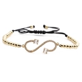 Pulsera ajustable símbolo infinito con circonitas brillantes y cordón negro trenzado - Infinito Dorado + Cuentas de Cobre Cuerda Negra