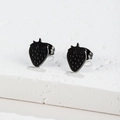 Macro shot of minimalist matte black strawberry earrings with realistic surface texture - Black