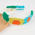 French crochet knit headband featuring colorful daisy flowers in emerald, blue, and yellow - Green