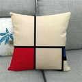 Close-up of linen cushion cover with Mondrian geometric pattern on a gray fabric sofa - Art Line and Block Style (Type D)