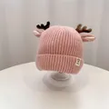 Pink knitted baby winter hat with reindeer antlers and ear protection for holiday warmth - 45-52cm / Pink