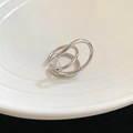 Macro detail of silver geometric double-layered open ring on a white ceramic plate - Ring (Silver) / Silver