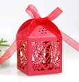 Detail of red laser-cut candy box with heart patterns and matching silk ribbon bow - Pearlescent Red