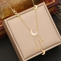 Detail of gold star and moon layered necklace on a jewelry box with vintage book - Star Moon Shell Fine Chain (6#)